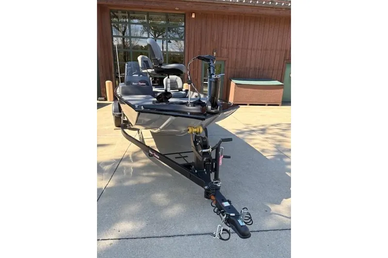 Slide: The Image of 2026 Tracker Bass Tracker Classic XL boat on trailer, parked outdoors. - 2
