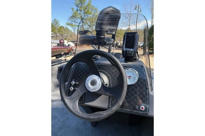 Slide: The Image of 2026 Tracker Bass Tracker Classic XL dashboard with steering wheel and navigation display. - 3