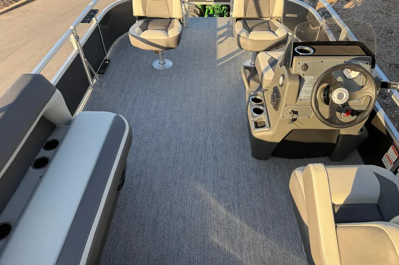 Slide: The Image of 2026 Sun Tracker Bass Buggy 16 XL Select interior with seating and steering console. - 3