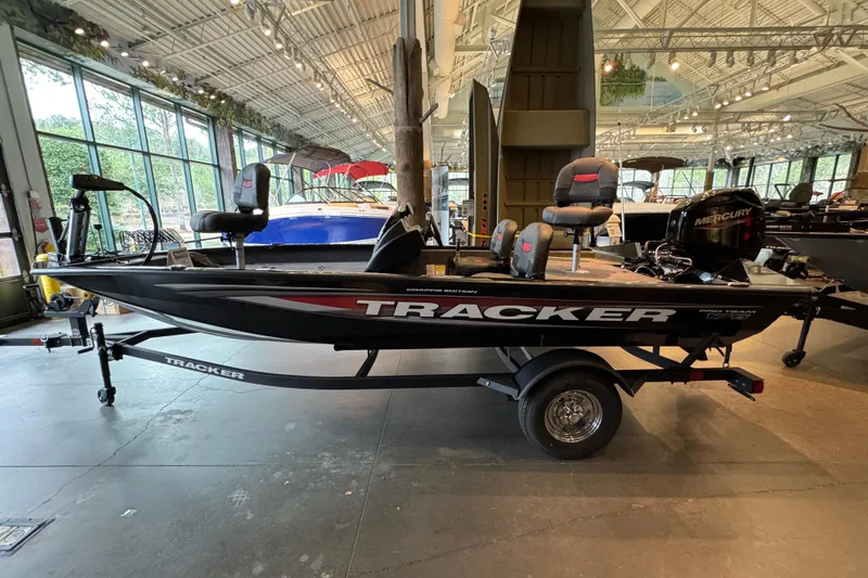 Slide: The Image of 2026 Tracker Pro Team 175 Crappie Edition boat displayed indoors on a trailer. - 58