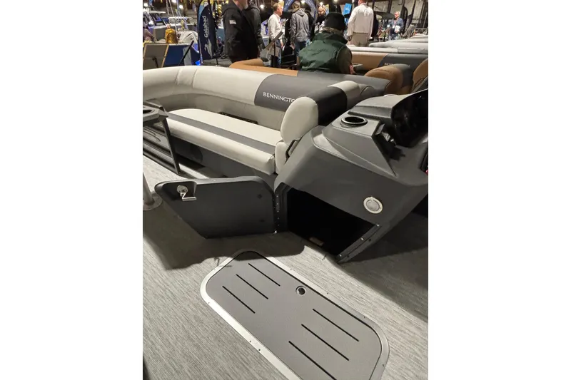 Slide: The Image of 2026 Bennington 22 S Swingback boat interior with seating and storage compartment. - 3