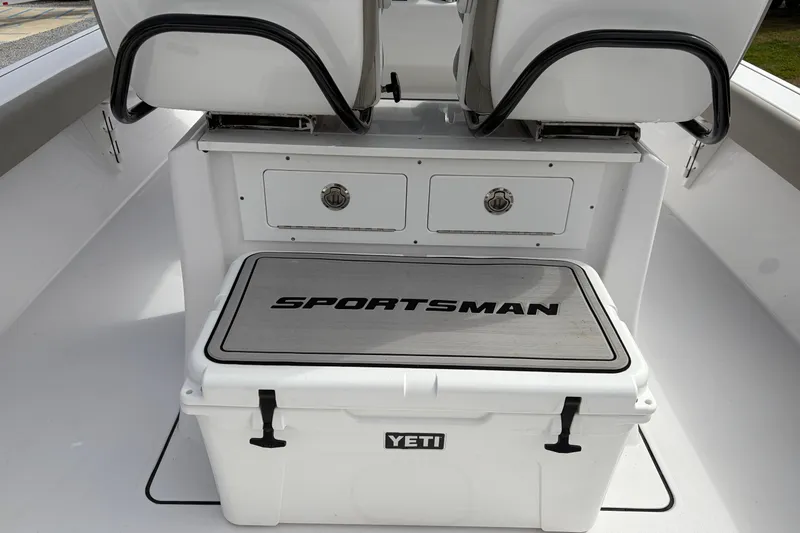 Slide: The Image of 2024 Sportsman Masters 267 Bay Boat interior with Yeti cooler and storage drawers. - 14