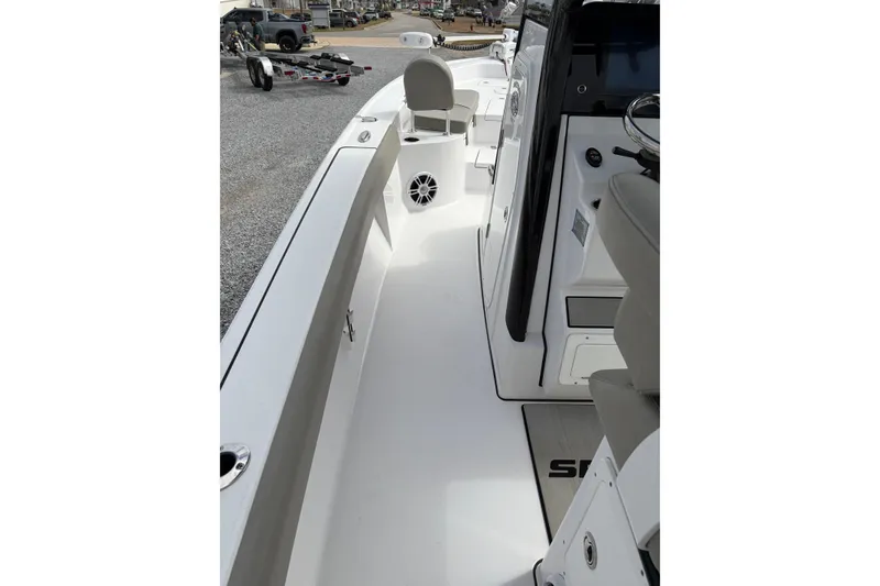 Slide: The Image of 2024 Sportsman Masters 267 Bay Boat interior with seating and console view. - 15