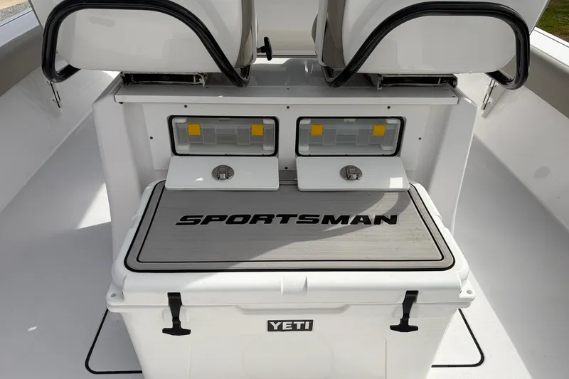 Slide: The Image of 2024 Sportsman Masters 267 Bay Boat interior with Yeti cooler and storage compartments. - 17