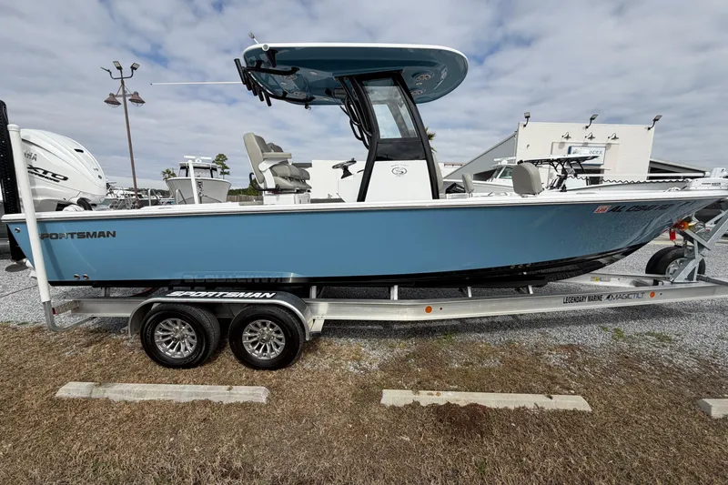 Slide: The Image of 2024 Sportsman Masters 267 Bay Boat on trailer, blue hull, outdoor display. - 3