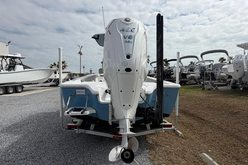 Slide: The Image of 2024 Sportsman Masters 267 Bay Boat with powerful outboard motor, displayed outdoors. - 6