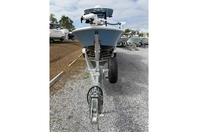 Slide: The Image of 2024 Sportsman Masters 267 Bay Boat on trailer, parked on gravel lot. - 7