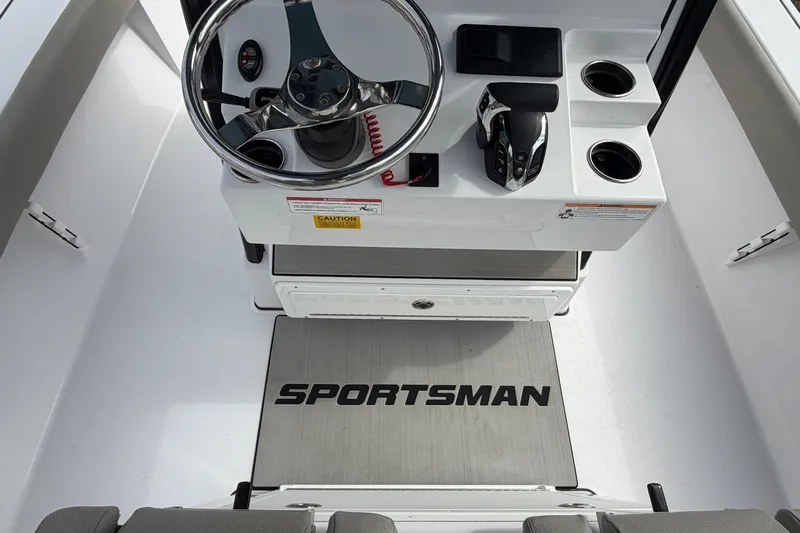 Slide: The Image of 2024 Sportsman Masters 267 Bay Boat helm with steering wheel and controls. - 8