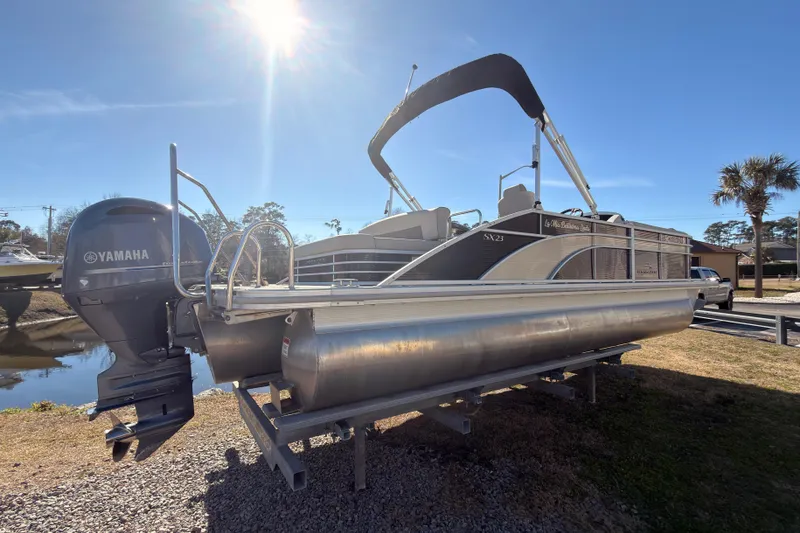 The Image of 2018 Bennington 23 SSBXP pontoon boat with Yamaha engine, parked outdoors under sunny sky. - 0