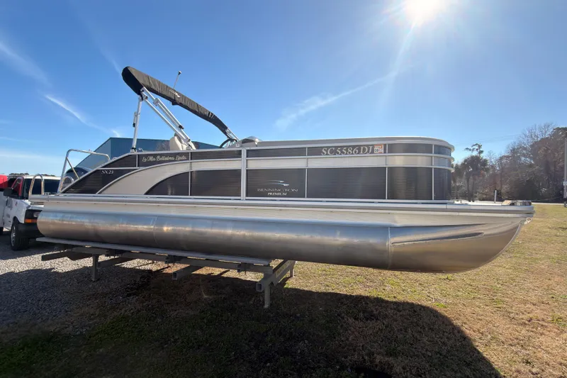 Slide: The Image of 2018 Bennington 23 SSBXP pontoon boat on trailer under bright sun. - 1