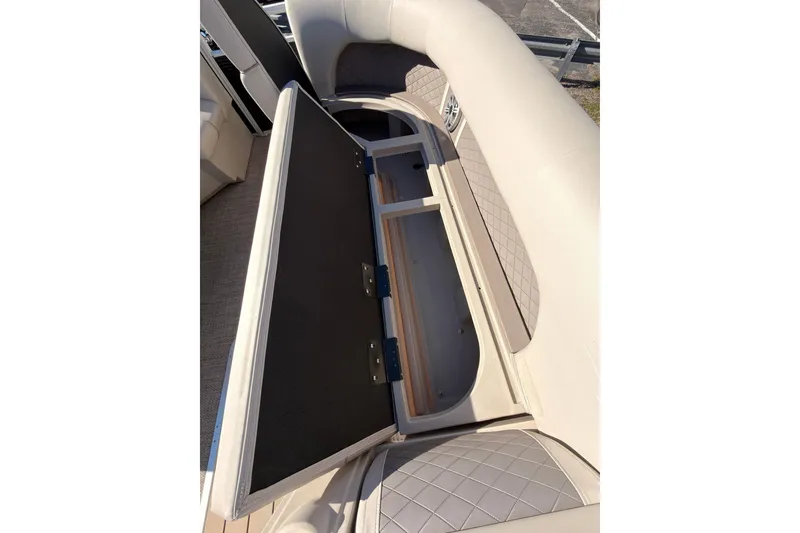 Slide: The Image of 2018 Bennington 23 SSBXP boat interior storage compartment with open cushioned seat. - 11