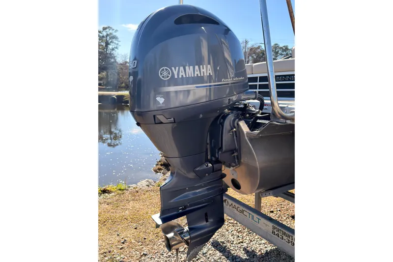 Slide: The Image of 2018 Bennington 23 SSBXP with Yamaha outboard motor by a serene lake. - 3