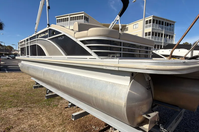 Slide: The Image of 2018 Bennington 23 SSBXP pontoon boat on display in a marina setting. - 6