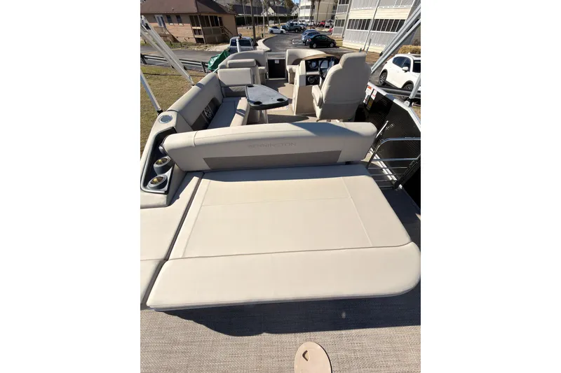 Slide: The Image of 2018 Bennington 23 SSBXP pontoon boat interior with beige seating and cup holders. - 7
