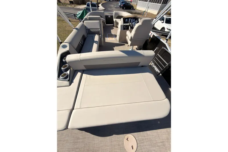 Slide: The Image of 2018 Bennington 23 SSBXP pontoon boat interior with beige seating and steering console. - 9