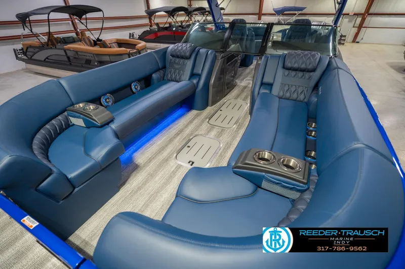 Slide: The Image of Luxurious interior of 2026 Bennington 27 RX boat with blue seating and cup holders. - 11