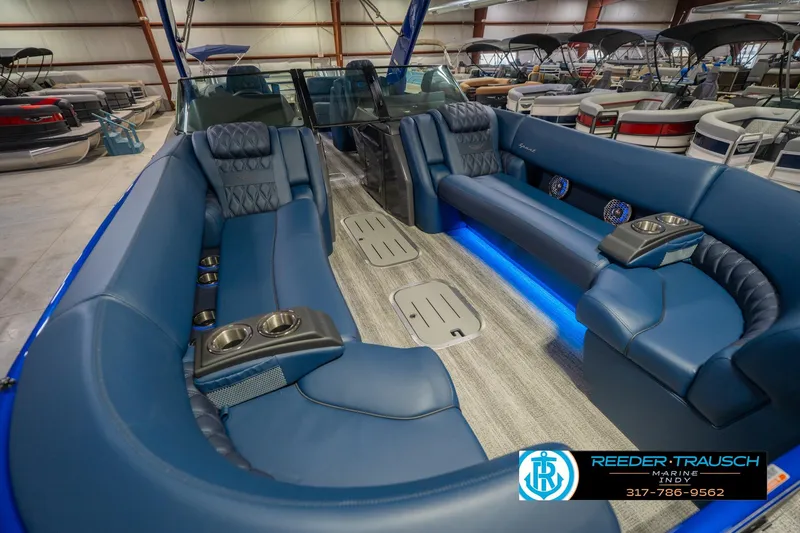 Slide: The Image of Luxurious interior of 2026 Bennington 27 RX pontoon boat with blue seating and ambient lighting. - 12