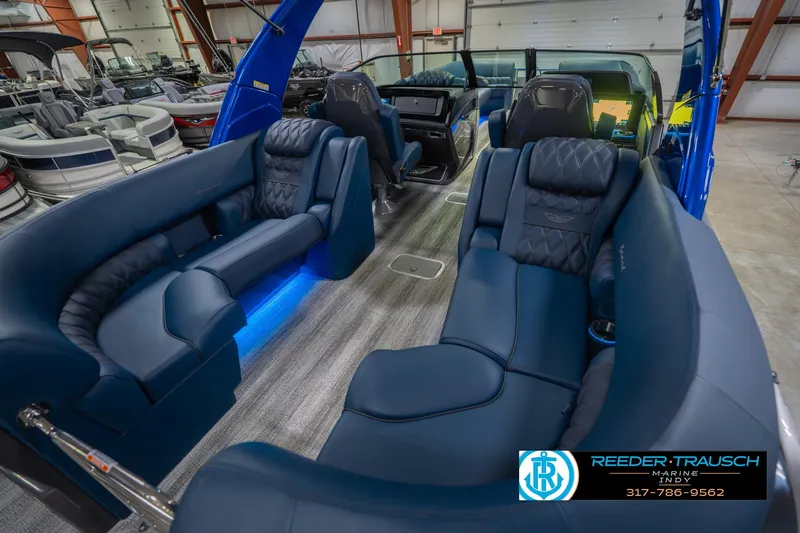 Slide: The Image of 2026 Bennington 27 RX boat interior with luxurious blue seating and modern design. - 13