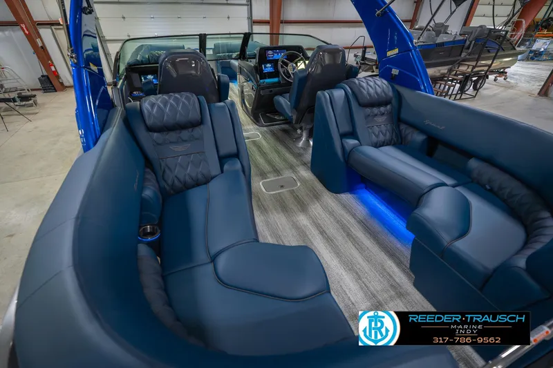 Slide: The Image of 2026 Bennington 27 RX boat interior with luxurious blue seating and modern dashboard. - 14