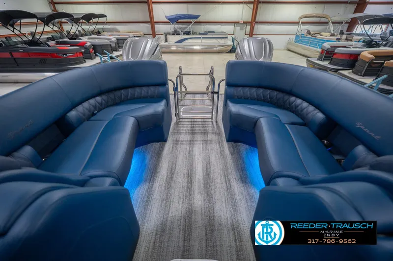 Slide: The Image of 2026 Bennington 27 RX pontoon boat interior with blue seating and ambient lighting. - 17