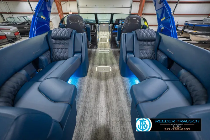 Slide: The Image of Luxurious interior of 2026 Bennington 27 RX boat with blue seating and ambient lighting. - 18
