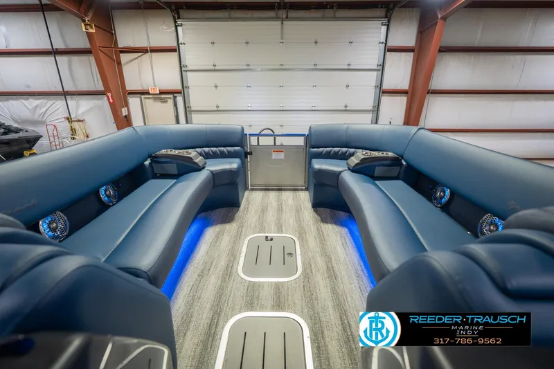 Slide: The Image of Luxurious interior of 2026 Bennington 27 RX pontoon boat with blue seating and LED lighting. - 20