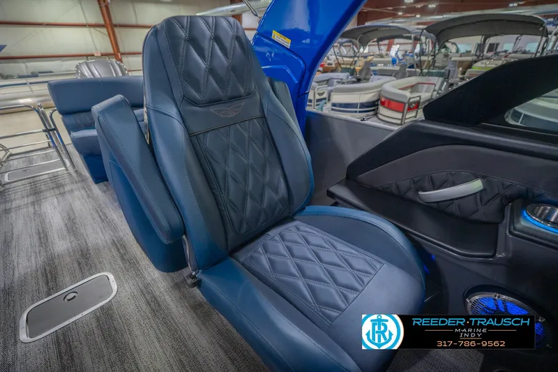 Slide: The Image of Luxurious interior seating of 2026 Bennington 27 RX boat, featuring premium blue upholstery. - 25