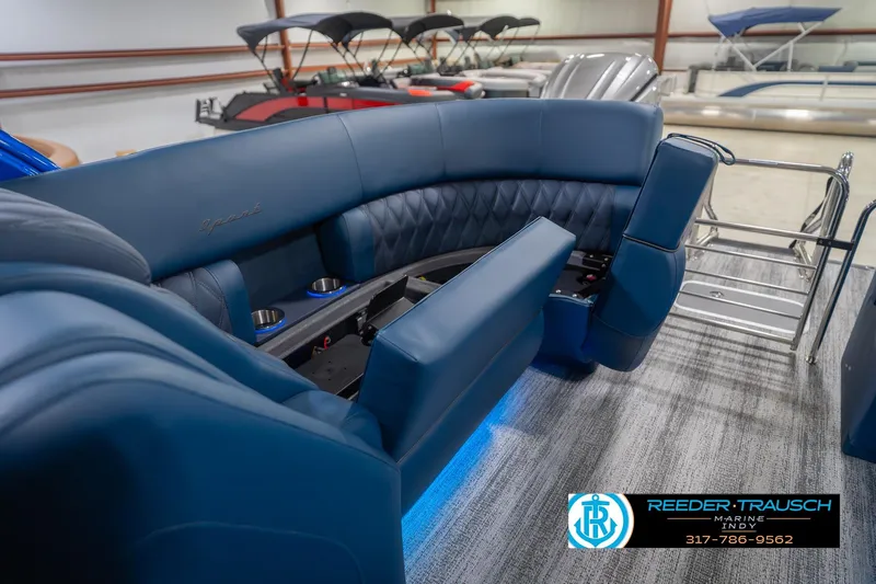 Slide: The Image of 2026 Bennington 27 RX boat interior with luxurious blue seating and cup holders. - 28