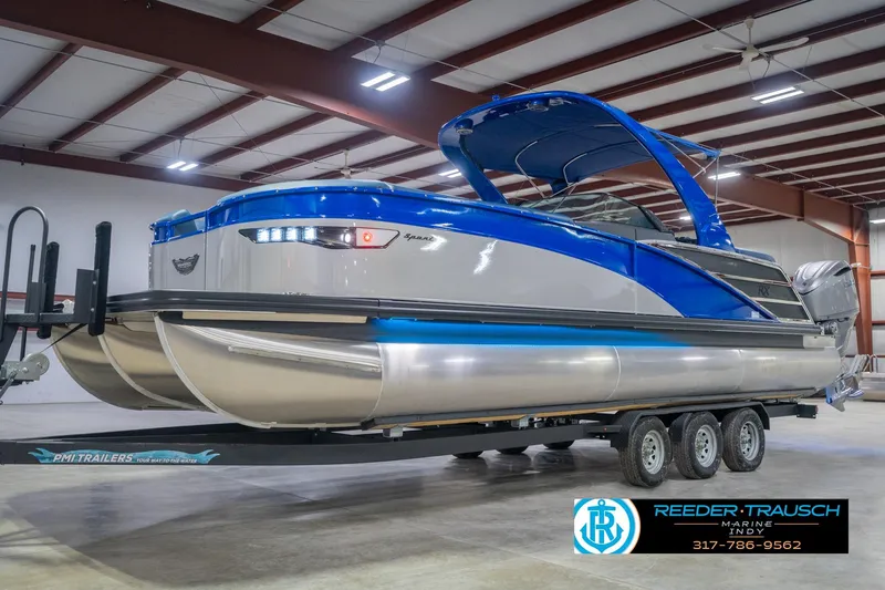 Slide: The Image of 2026 Bennington 27 RX pontoon boat on trailer in indoor showroom. - 3