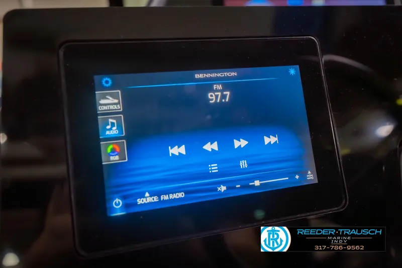 Slide: The Image of Touchscreen display of 2026 Bennington 27 RX showing FM radio controls at 97.7 frequency. - 32