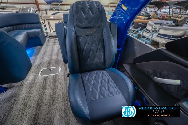 Slide: The Image of 2026 Bennington 27 RX boat interior with luxurious blue seating and modern design. - 38