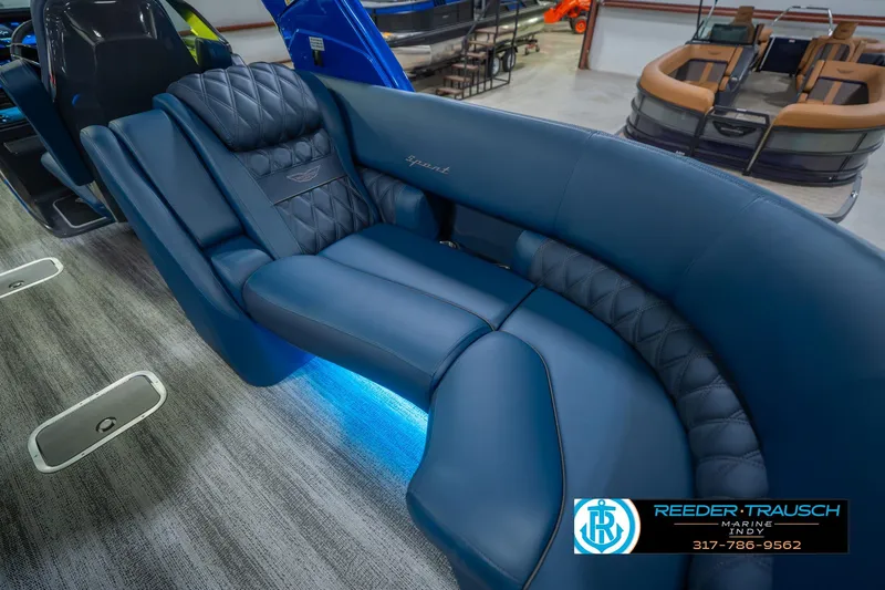 Slide: The Image of Luxurious seating on 2026 Bennington 27 RX boat with blue upholstery and ambient lighting. - 40