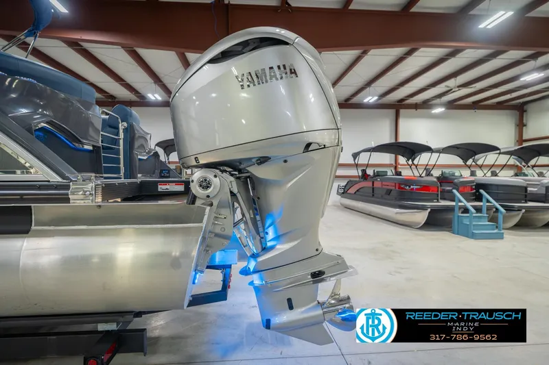 Slide: The Image of 2026 Bennington 27 RX pontoon boat with Yamaha outboard motor in showroom. - 47