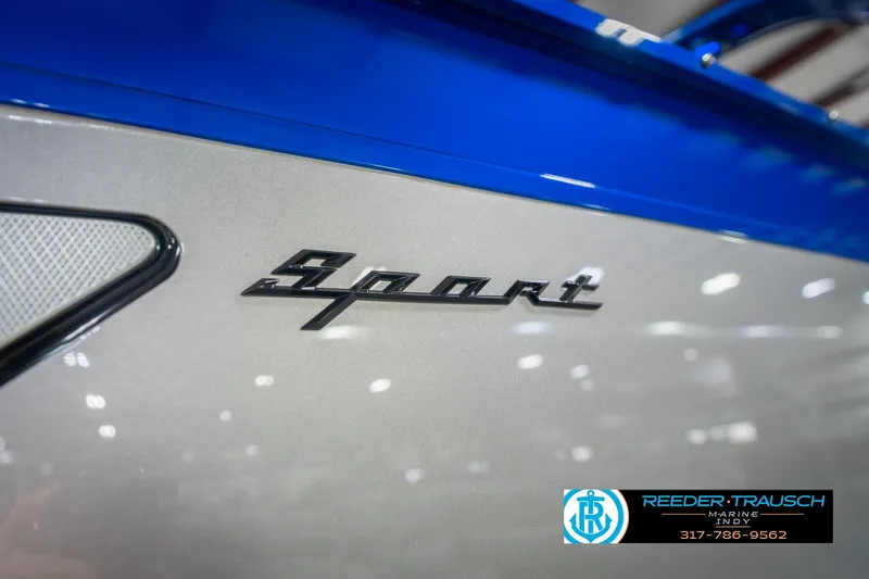 Slide: The Image of 2026 Bennington 27 RX Sport logo on sleek blue and silver boat exterior. - 52