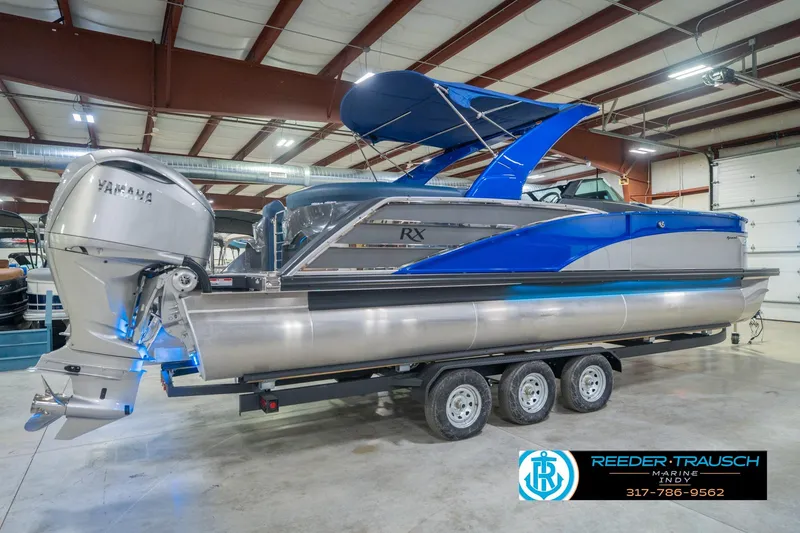 Slide: The Image of 2026 Bennington 27 RX pontoon boat with Yamaha engine in showroom. - 7