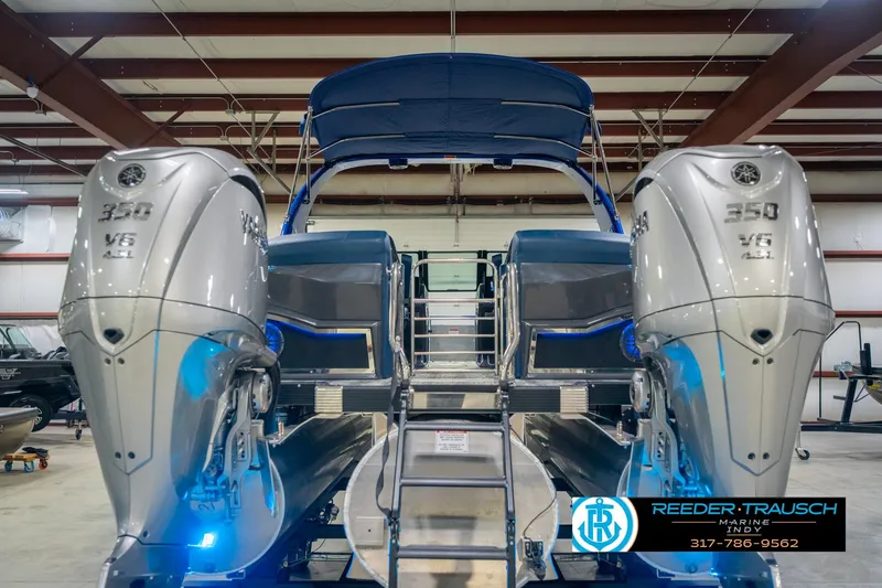Slide: The Image of 2026 Bennington 27 RX boat with dual 350 V6 engines in a showroom. - 8