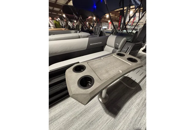 Slide: The Image of 2026 Bennington 23 SSB SF boat interior with table and cup holders. - 5