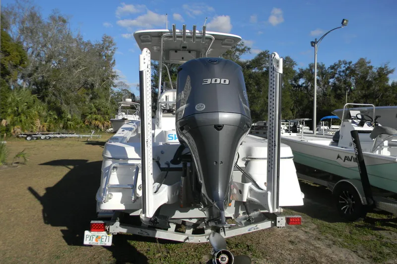 Slide: The Image of 2021 BlackJack 256 Coastal boat with powerful 300 HP engine, parked outdoors. - 5