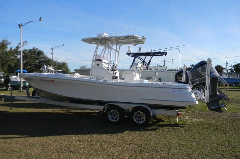 Slide: The Image of 2021 BlackJack 256 Coastal boat on trailer, parked outdoors under clear sky. - 6