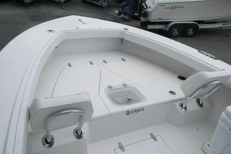 Slide: The Image of 2021 BlackJack 256 Coastal boat interior with seating and storage compartments. - 7