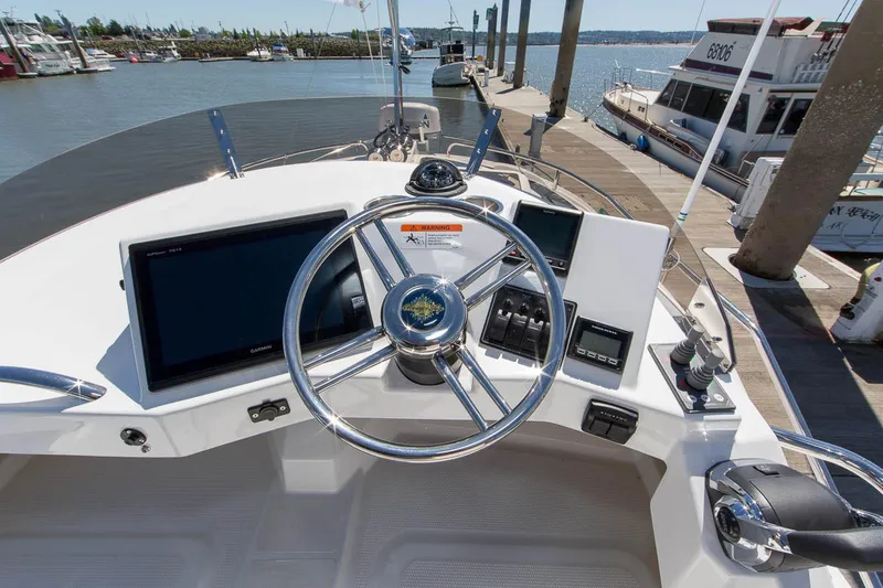 Slide: The Image of Manufacturer Provided Image: 2025 Ranger Tugs R-29 CB helm with modern navigation equipment at a marina. - 5