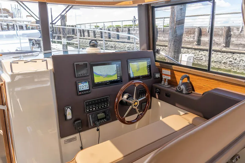 Slide: The Image of Manufacturer Provided Image: 2025 Ranger Tugs R-29 CB helm with navigation screens and steering wheel. - 8