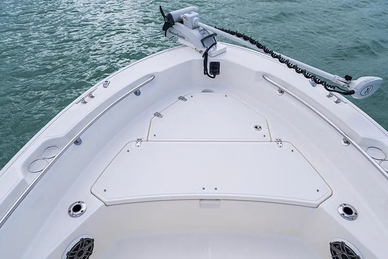 Slide: The Image of Manufacturer Provided Image: 2026 Boston Whaler 220 Dauntless boat deck with trolling motor on calm water. - 7