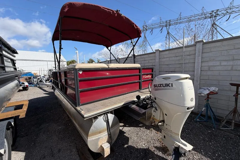 Slide: The Image of 2020 Bentley Pontoons 200 Fish with Suzuki outboard motor, parked outdoors. - 4