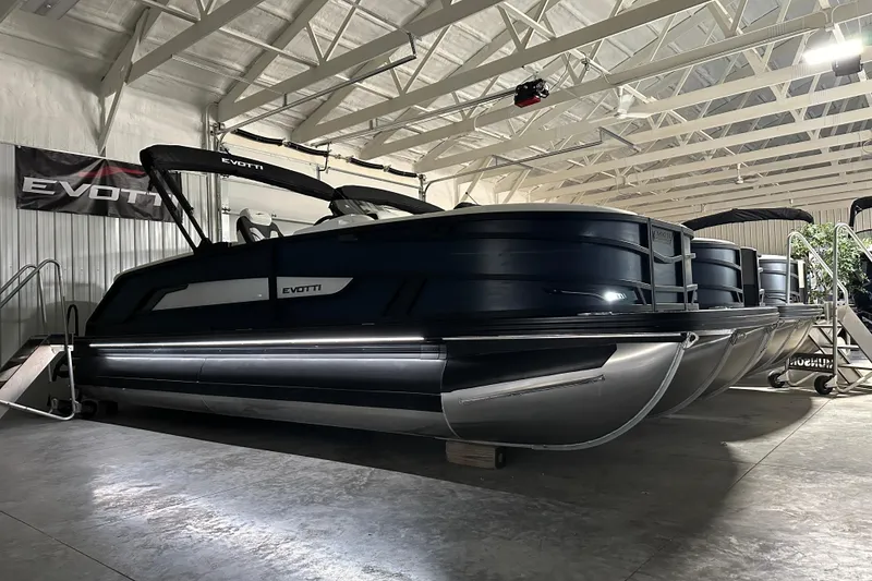 Slide: The Image of 2026 Evotti 723 QL pontoon boat in a well-lit indoor showroom. - 1