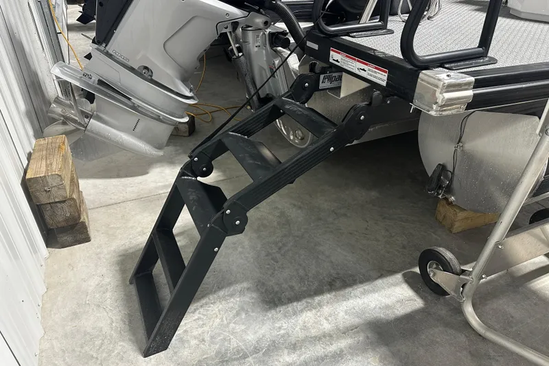 Slide: The Image of 2026 Evotti 723 QL boat with foldable ladder and outboard motor in storage. - 13