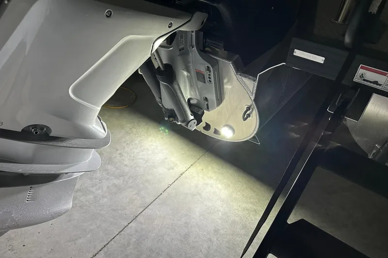 Slide: The Image of Close-up of 2026 Evotti 723 QL boat motor with illuminated details in a garage. - 19