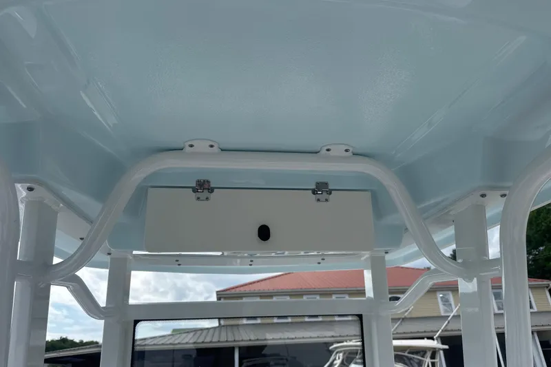 Slide: The Image of 2026 Robalo 246 Cayman boat interior ceiling with storage compartment. - 10