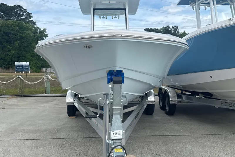 Slide: The Image of 2026 Robalo 246 Cayman boat on trailer, front view, outdoors. - 3