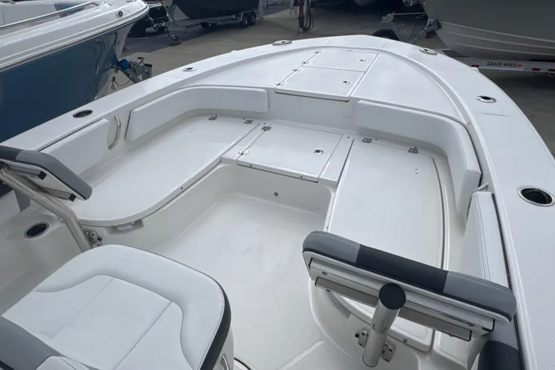 Slide: The Image of 2026 Robalo 246 Cayman boat interior with spacious seating and storage compartments. - 4